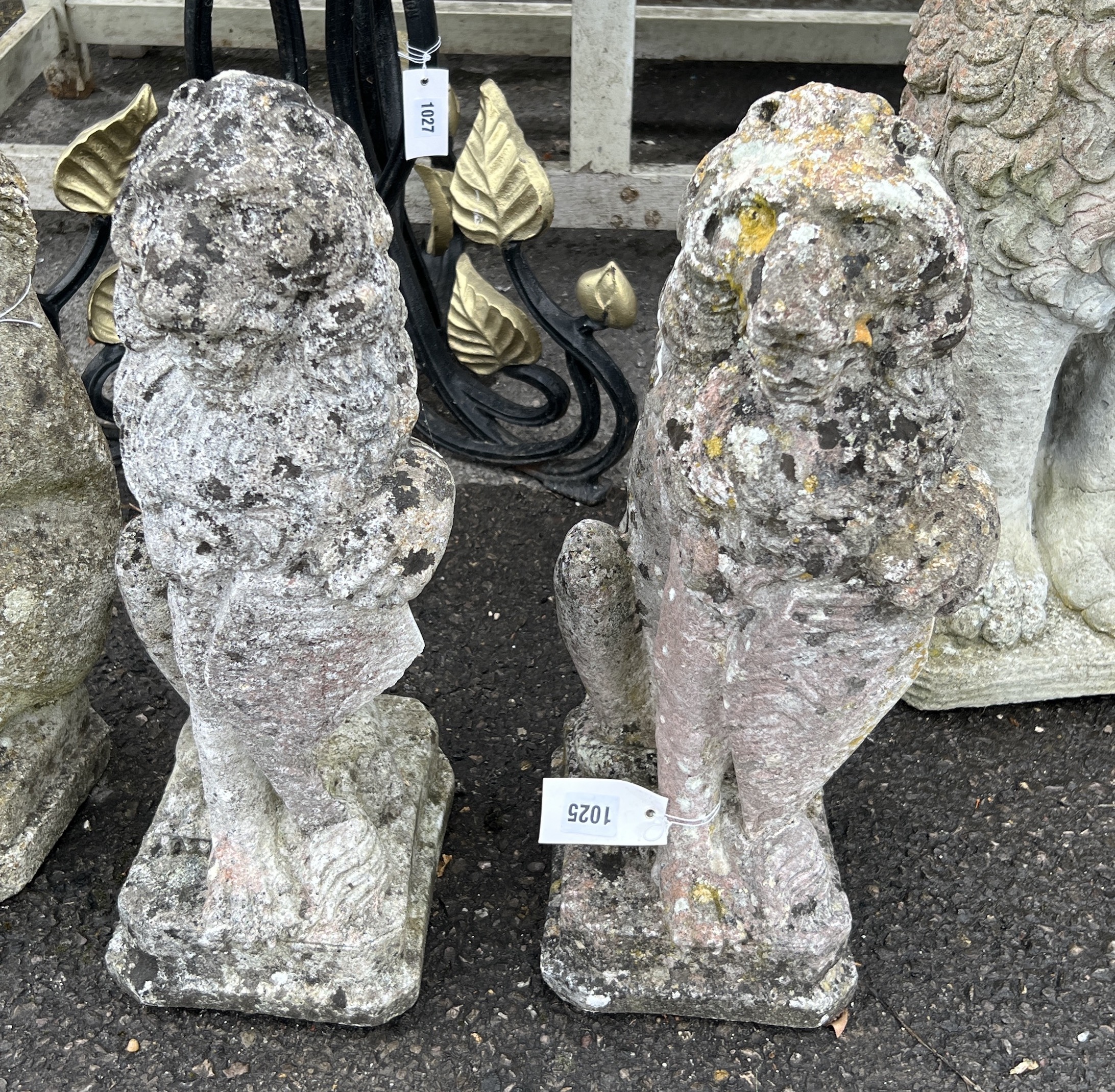 A pair of reconstituted stone heraldic lion garden ornaments, height 52cm